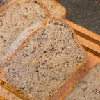 Slices of whole grain bread on a wooden cutting board